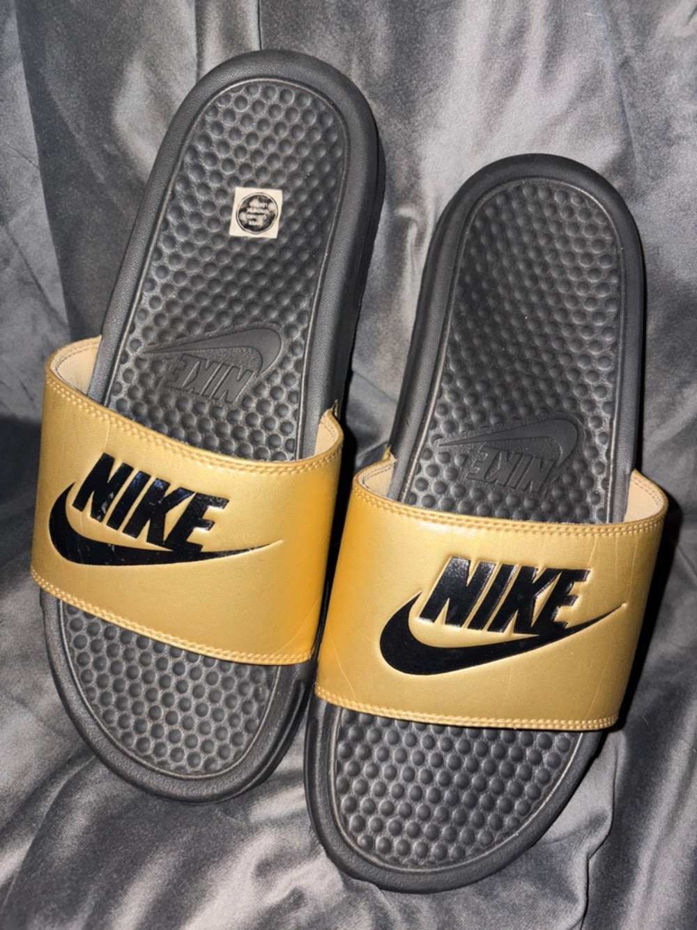 Nike Black and Gold Slide Sandals with Bold Logo
